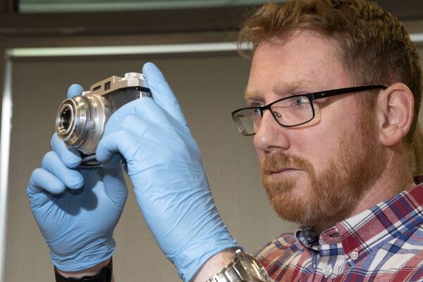 Noel Campbell, Assistant Keeper at the National Museum of Ireland, Country Life, with a Regula camera from the Wynne Collection. Picture: Alison Laredo