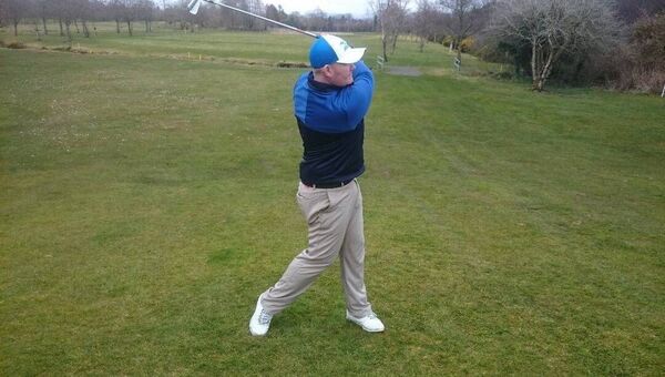 Pic 2: During the swing maintain your posture by keeping your head still and your legs quiet. 