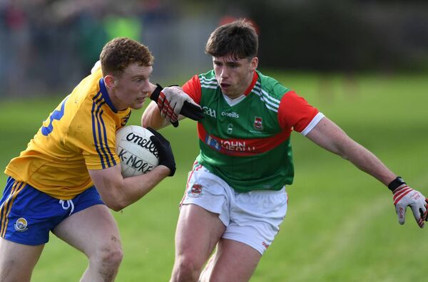 Ballina defender Sam Callanan keeps close tabs on Knockmore attacker Aiden Orme. 