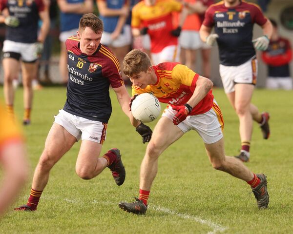  John MacMonagle protects the ball for Castlebar Mitchels while under pressure from Ballinrobe's Liam Burke.