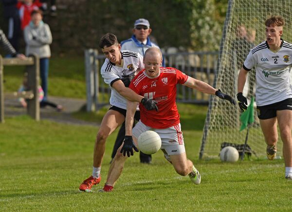 Kilmeena's Jack Mulchrone applies pressure upon Moy Davitts attacker Brian Heneghan.