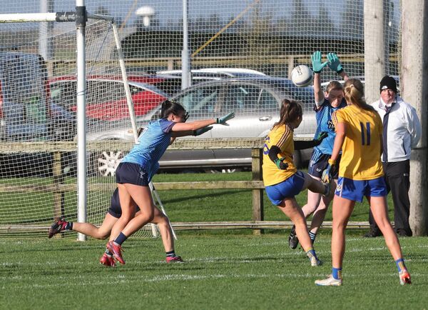 Emma Lowther of Knockmore fires over a point against Westport.