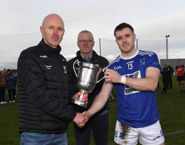 Sean O’Reilly, chairman of the Mayo Hurling Committee, presents the TJ Tyrell Cup to Tooreen captain Shane Boland. Also included is Mayo GAA chairman Seamus Tuohy.