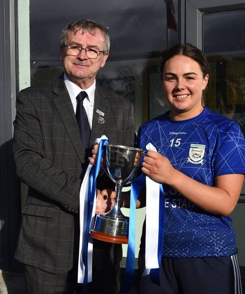 Claremorris captain, Laura Kelly, receives the Connacht LGFA Junior Cup from Connacht LGFA President, Con Moynihan, after the Connacht LGFA junior football championship cup final in Boyle last Sunday.