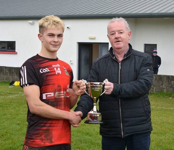 Brian Harte presents Davitts captain Ciaran Treacy with the cup. Brian Harte presents Davitts captain Ciaran Treacy with the cup.