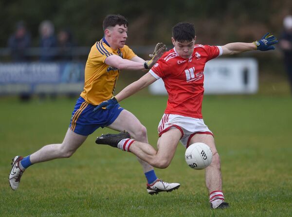 Cathal Clarke gets ready to kick for the posts despite pressure from Knockmoree wing-back Oran Timlin. Cathal Clarke gets ready to kick for the posts despite pressure from Knockmoree wing-back Oran Timlin.