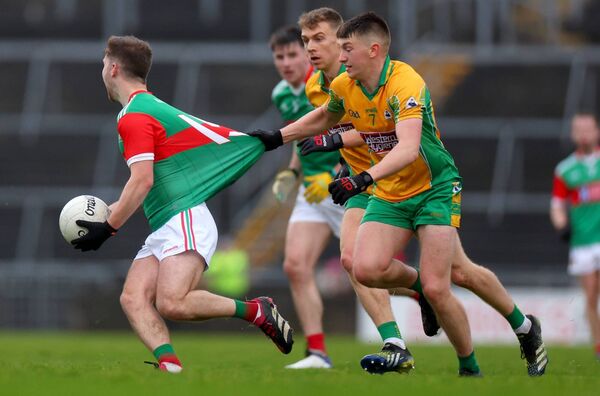 Conor McStay has the quality of his Ballina jersey tested by Brian Cogger of Corofin. Conor McStay has the quality of his Ballina jersey tested by Brian Cogger of Corofin.
