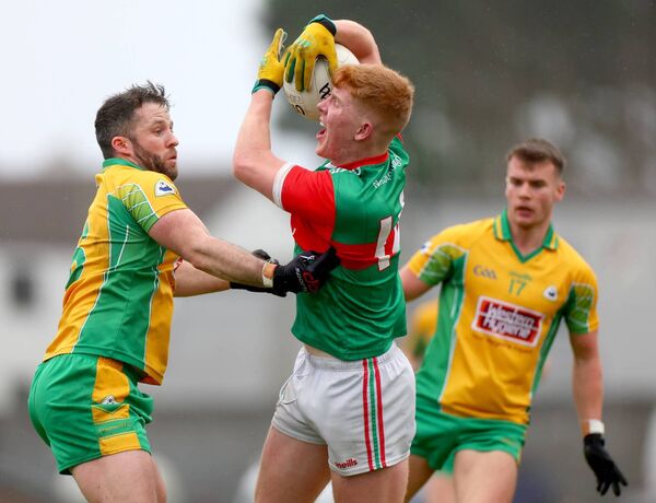 Corofin’s Conor Cunningham blocks the path of Ballina full-forward Luke Feeney. Corofin’s Conor Cunningham blocks the path of Ballina full-forward Luke Feeney.