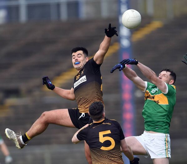 Darragh Walsh of Lahardane contests the ball at midfield with Menlough’s Colm O’Brien as Aaron Murphy awaits the outcome. 