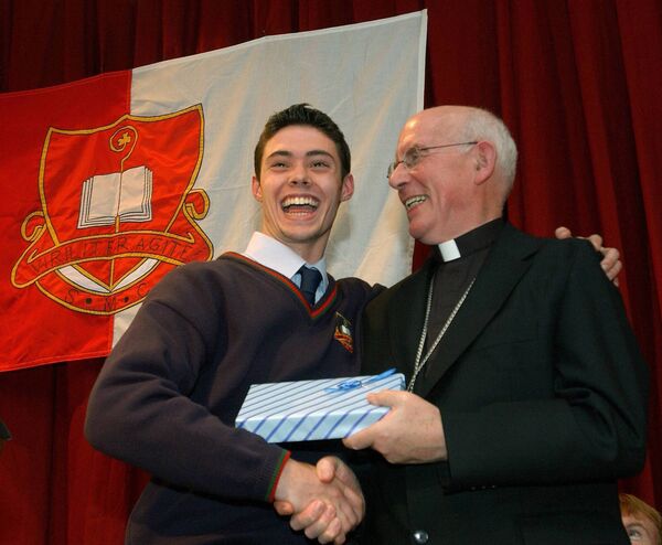 Welcome to St Muredach's, Archbishop - St Muredach's College pupil, Tommie Timlin, shows his delight as he makes a special presentation to All-Ireland Primate Archbishop Sean Brady, at the college's centenary celebrations in 2006. 