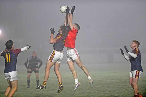 Garrymore's Liam Og Horkan and Ballinrobe's Peter Finnerty contest a high ball during the South Mayo Junior A final in Ballinrobe on Friday night. Picture: Conor McKeown