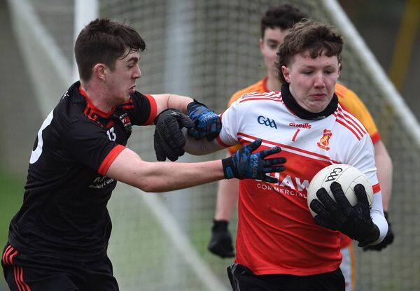 Castlebar Mitchels goalkeeper Peter Basquille is challenged by Davitts Dylan Gallagher.