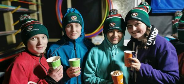 Four participants enjoy a well-deserved post-workout hot chocolate after their session.