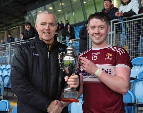 Mayo GAA chairman Seamus Tuohy presents Diarmaid Walsh, captain of Crossmolina Deel Rovers, with the U21 'B' trophy.