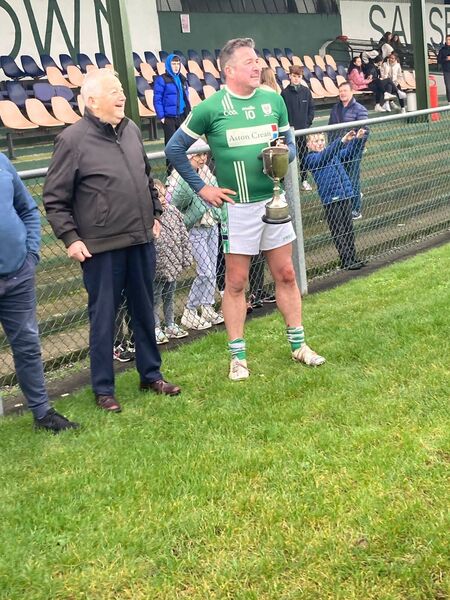 Tony Conway receiving the Michael Byrnes Memorial Cup from Michael Byrnes (Snr) having skippered the over 30s brigade to a contentious victory. Tony Conway receiving the Michael Byrnes Memorial Cup from Michael Byrnes (Snr) having skippered the over 30s brigade to a contentious victory.