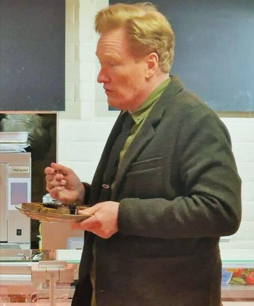 Conan O'Brien sampling Loughnane's famous black pudding.