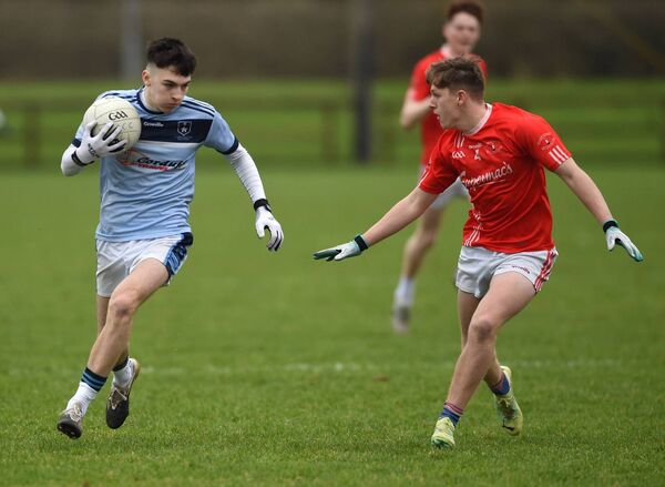 Cian Walsh of St Gerald’s takes on Tom Hession of St Colman’s. 