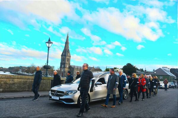 Henry Wills’ funeral cortege makes its way across the Ham Bridge in Ballina with St Muredach’s Cathedral in the background.	Picture: John O’Grady
                    