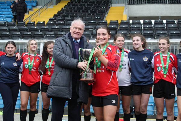 Mila Sotoparra accepts the FAI Schools Senior 'B' Cup on behalf of St Joseph's Secondary School following their victory in Athlone.