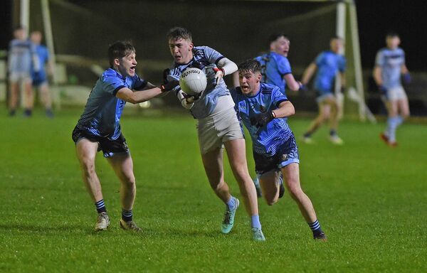 Fionan O'Reilly of St Gerald's gets his pass away despite the attention from behind of Summerhill's Conor Flynn. Fionan O'Reilly of St Gerald's gets his pass away despite the attention from behind of Summerhill's Conor Flynn.