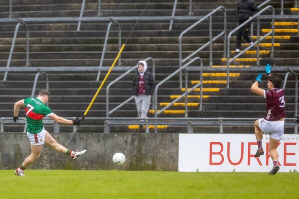 Mayo's Eoghan McLaughlin fires the ball past Galway full-back Sean Fitzgerald to score a first-half goal. Mayo's Eoghan McLaughlin fires the ball past Galway full-back Sean Fitzgerald to score a first-half goal.