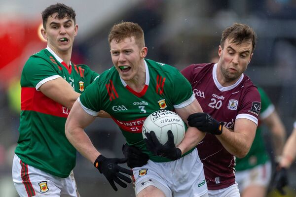 David McBrien carries the ball out of defence for Mayo under pressure from Galway's Paul Conroy. David McBrien carries the ball out of defence for Mayo under pressure from Galway's Paul Conroy.