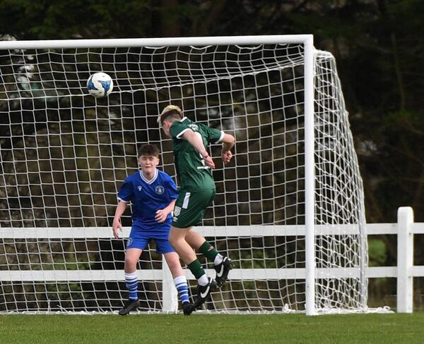 Mayo FC’s Ronan McElevey heads his side’s second goal against Limerick. 