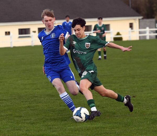 Mayo FC’s Eoghan Powell gets past Limerick’s Adam Ryan. 