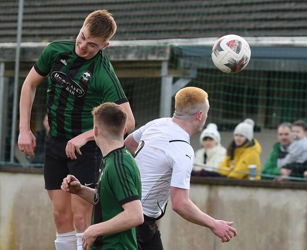  Conn Rangers’ Oisin McDonagh heads the ball clear of Ballyheane opponent Michael Fahy as Conn Rangers Sean Holmes awaits the outcome.