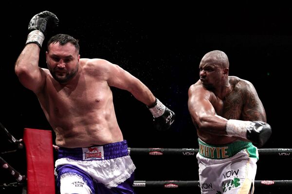 Two-time WBC Heavyweight champion Dillian Whyte rains blows down upon Christian Hammer in the main event. INPHO/Laszlo Geczo