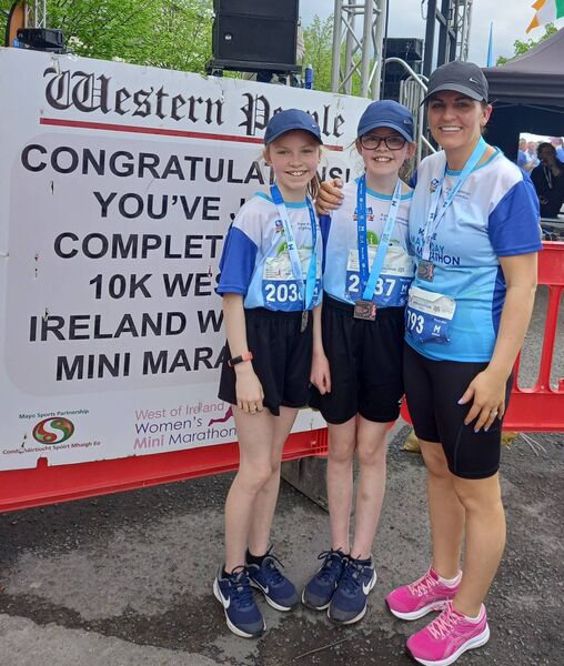 Ella Ginty, aged 11, and Holly Ginty, aged nine, from Foxford with their mum Jennifer after all three ran the entire 10k Mayo.ie Western People West of Ireland Women’s Mini Marathon in Ballina last year. 