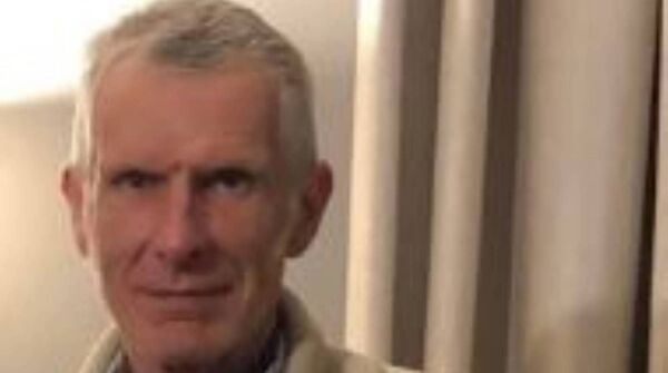 Nicholas Taylor is described as being 6 foot tall with a slim build. He has grey hair and blue eyes Nicholas Taylor is described as being 6 foot tall with a slim build. He has grey hair and blue eyes