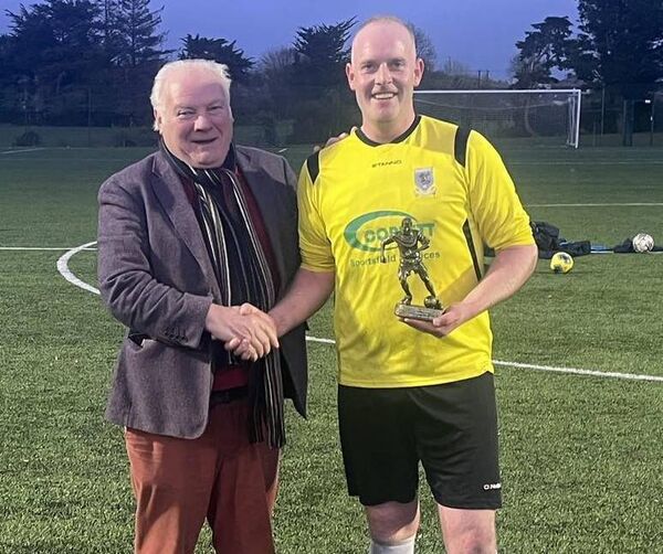 Man of the Match Mark Gibbons accepts his award from Masters Cup sponsor Oliver Kelleher.