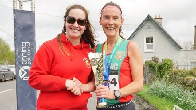<p>Paula Donnellan Walsh of Mayo AC accepts her prize for finishing second in the Kilkishen 10 mile where she ran a personal best time.</p>