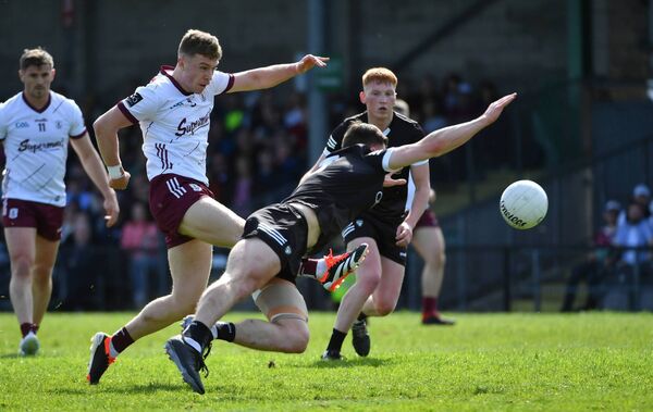 Sligo full-back Eddie McGuinness blocks a shot from Dylan McHugh of Galway.