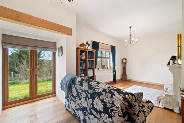 The living room area has an abundance of natural light and is tastefully finished