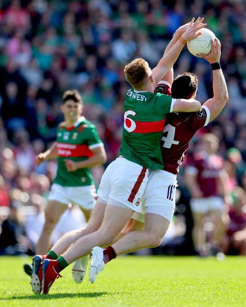 Mayo full-back David McBrien challenges Galway's Damien Comer.