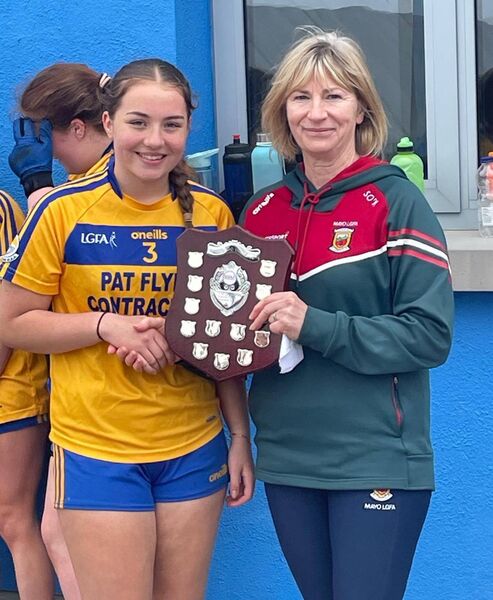 Knockmore captain Saidhibh Staunton accepts the Division 1 shield. 