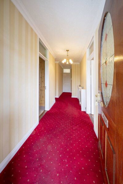 The hallway leading to the four bedrooms, living room and kitchen areas The hallway leading to the four bedrooms, living room and kitchen areas