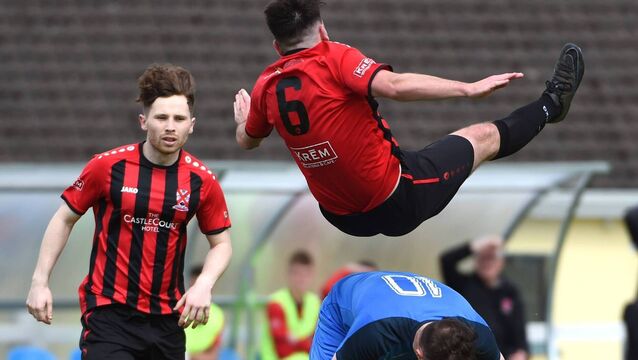 <p>Soft Landing! Westport United’s Fionn O’Hora lands safely on the back of Moyne Villa’s Padraic Cunningham. Picture: David Farrell Photography </p>