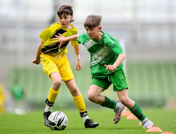 Matthew Tierney of St Joseph's PS, Ballinrobe, Mayo, in action against Diarmuid McFadden of Illistrin NS, Donegal, left, during the FAI Primary 5s Finals day at Aviva Stadium in Dublin. Picture: Stephen McCarthy/Sportsfile Matthew Tierney of St Joseph's PS, Ballinrobe, Mayo, in action against Diarmuid McFadden of Illistrin NS, Donegal, left, during the FAI Primary 5s Finals day at Aviva Stadium in Dublin. Picture: Stephen McCarthy/Sportsfile