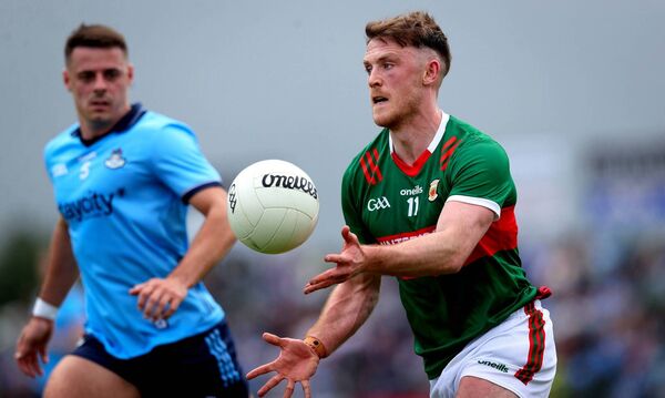 Darren McHale sends Mayo on the attack as Dublin's Brian Howard looks on.	Picture: INPHO/Ryan Byrne