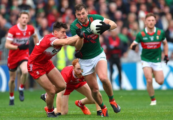Derry’s Conor Doherty and Conor Glass, both of whom would score penalties in the shoot-out, are unable to prevent Aidan O'Shea from bursting through to score a point for Mayo. Derry’s Conor Doherty and Conor Glass, both of whom would score penalties in the shoot-out, are unable to prevent Aidan O'Shea from bursting through to score a point for Mayo.
