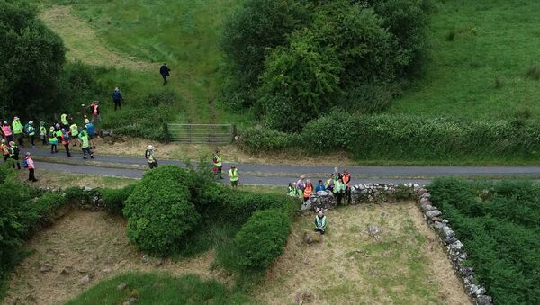 Participants in the Tóchar Phádraig walk take a moment of reflection at a Cillin at Ballyburke, Killawalla on the ancient pilgrim route to Croagh Patrick. Picture by Tom Quinn