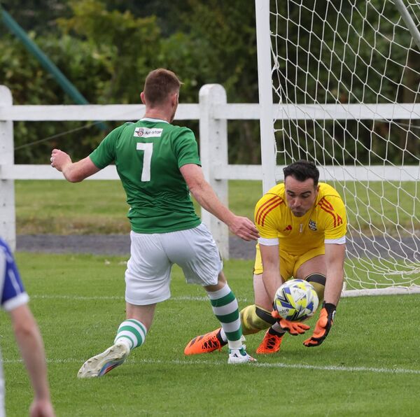 Castlebar Celtic's Niall Brennan (wearing) is beaten to the ball by Ballina Town goalkeeper Emmet Peyton. Castlebar Celtic's Niall Brennan (wearing) is beaten to the ball by Ballina Town goalkeeper Emmet Peyton.