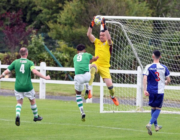 Ballina Town goalkeeper collects the ball ahead of Castlebar Celtic's Jordan Loftus (wearing 9). Ballina Town goalkeeper collects the ball ahead of Castlebar Celtic's Jordan Loftus (wearing 9).
