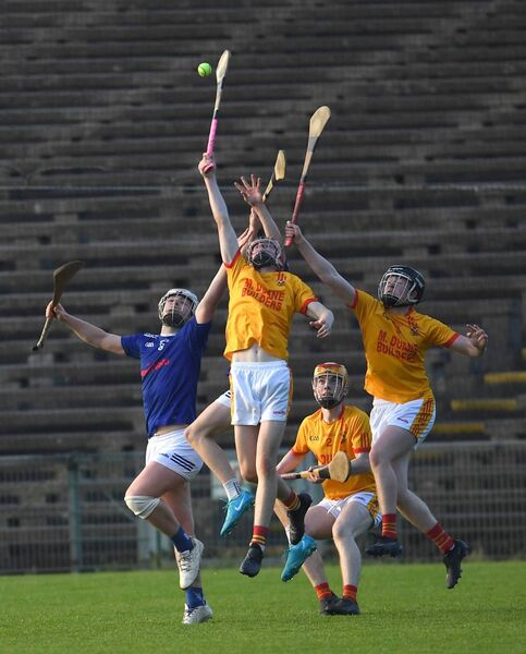 Tooreen and Castebar Mitchels players concentrate on the sliothar. Tooreen and Castebar Mitchels players concentrate on the sliothar.