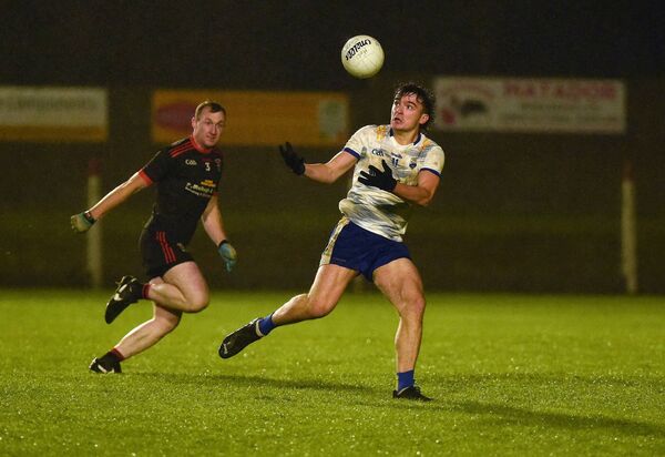 Hollymount/Carramore's Dylan Morris tries to gather possession with Davitts full-back Cathal Higgins closing down. Picture: Conor McKeown