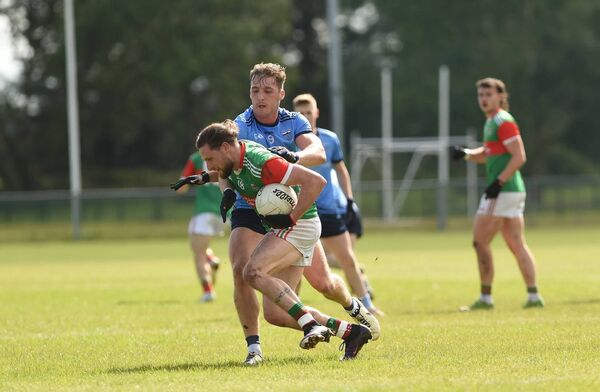 Ballina Stephenites Padraig O'Hora tries to hold off the challenge from Westport's Eoghan McLaughlin. Picture: Conor McKeown