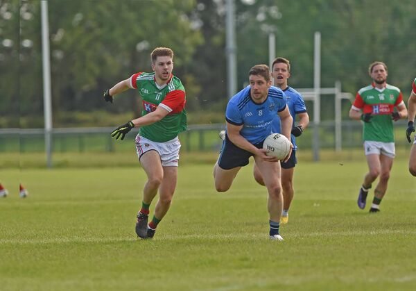 Westport's Lee Keegan breaks forward despite the efforts of Ballina's Conor McStay. Picture: Conor McKeown
